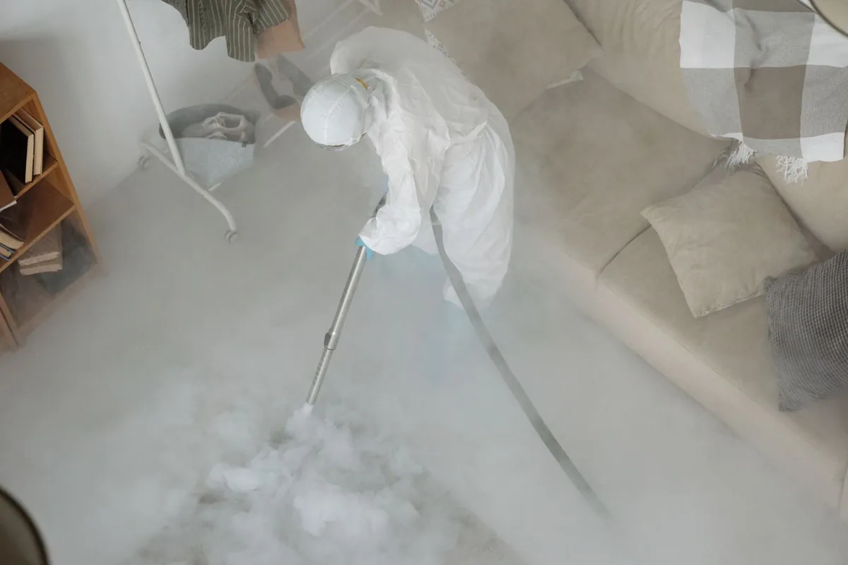 Biohazard cleanup technician in protective equipment, Needville, TX